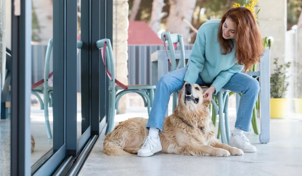 Full shot woman petting happy dog